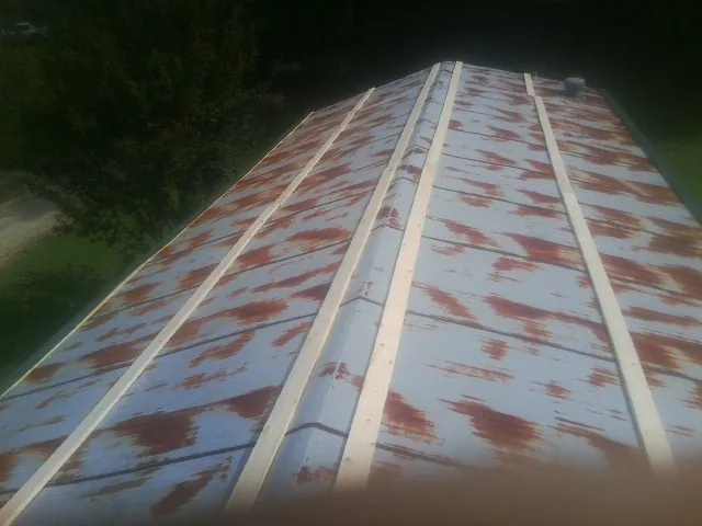 Rusted metal roof panels with new wood purlins before replacement — Storm Damage Roof Repair in Loxahatchee by Roofing Brothers