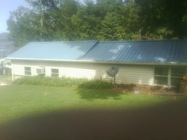 Blue metal roof running the length of a single story home in Loxahatchee
